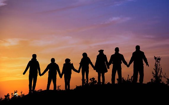 silhouettes of people on mountains